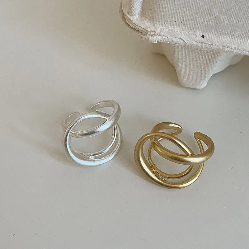 Geometric open ring with interlaced matte metal design in gold or silver electroplated finish