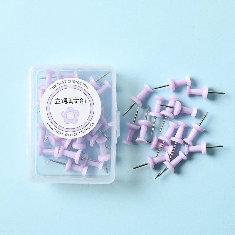 Plastic push pins in mint green, lavender, and pink, showing large and small sizes in a small box.