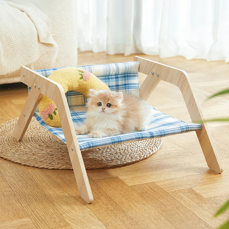 Blue wooden elevated cat bed with fabric hammock for indoor feline lounging