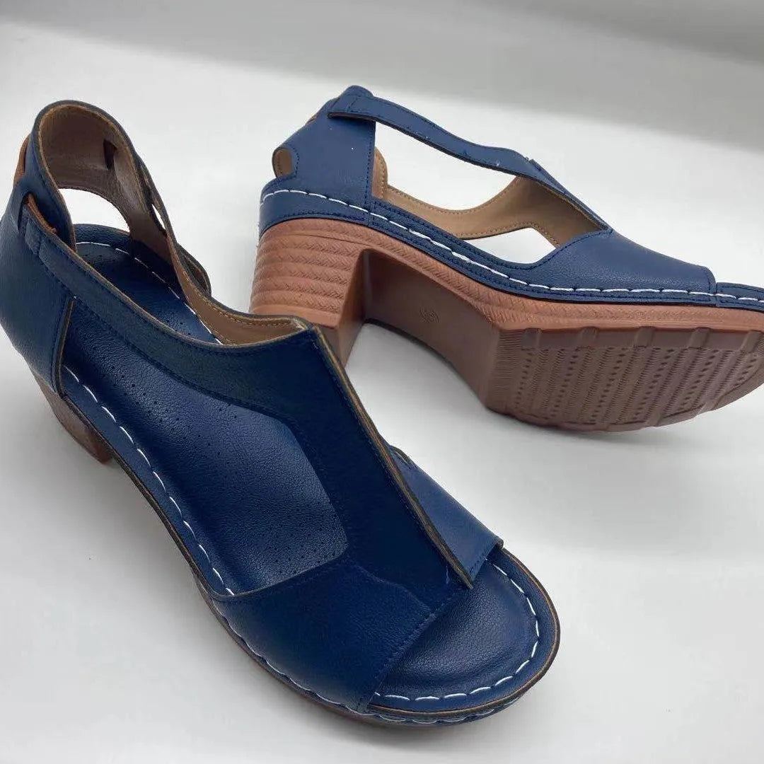 Women's beige peep toe wedge sandals with a buckle strap and low Roman-style heel.