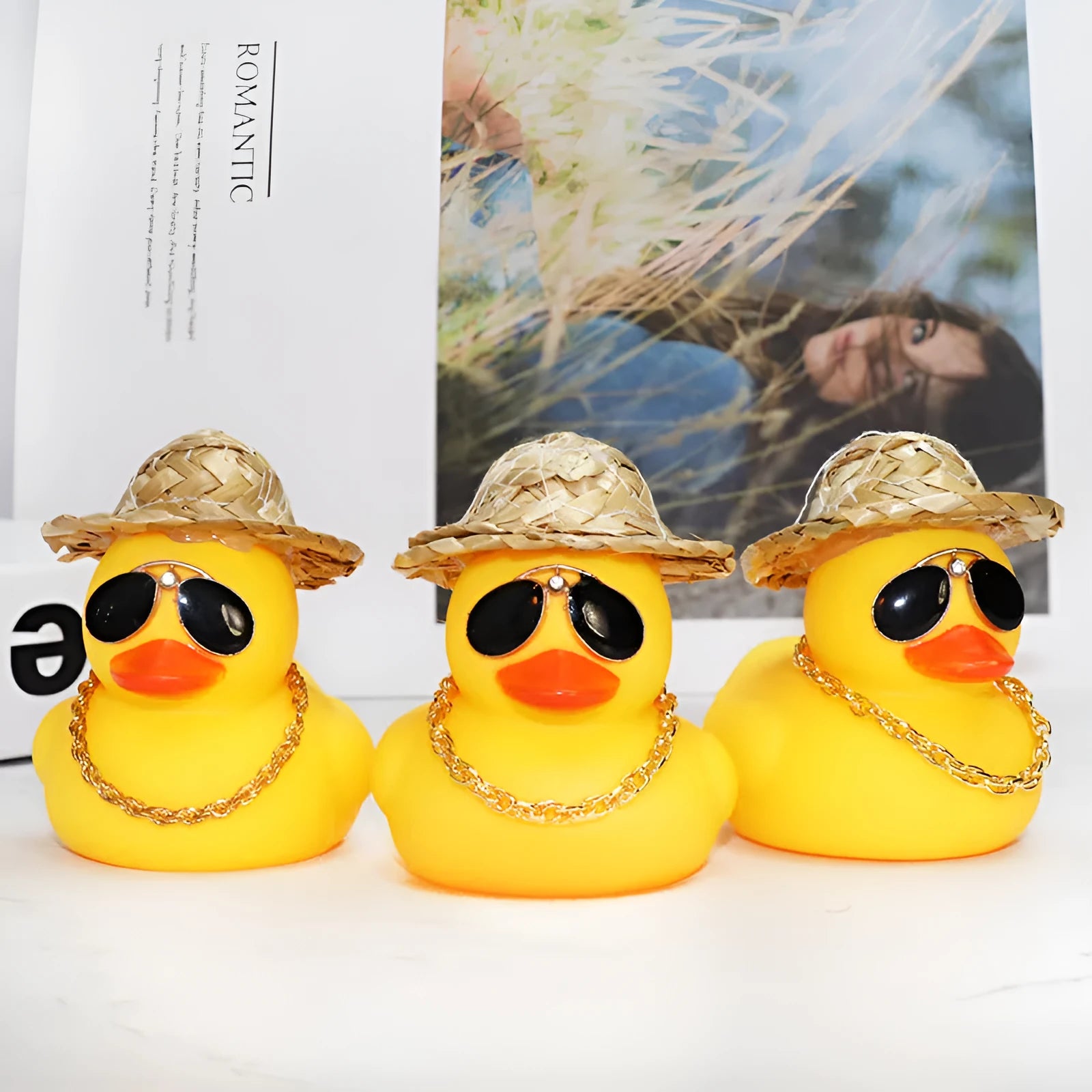 Straw hat yellow duck car dashboard ornament with removable sunglasses necklace on adhesive base.