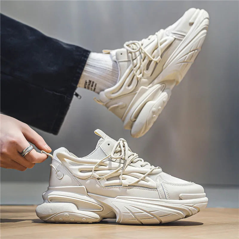 Men's beige and black low-top sneakers with mesh upper and rubber sole, showing lace-up front.