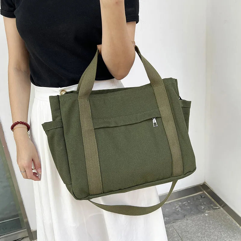 Canvas tote bag showing multiple internal compartments and both sides zipper openings in horizontal square shape