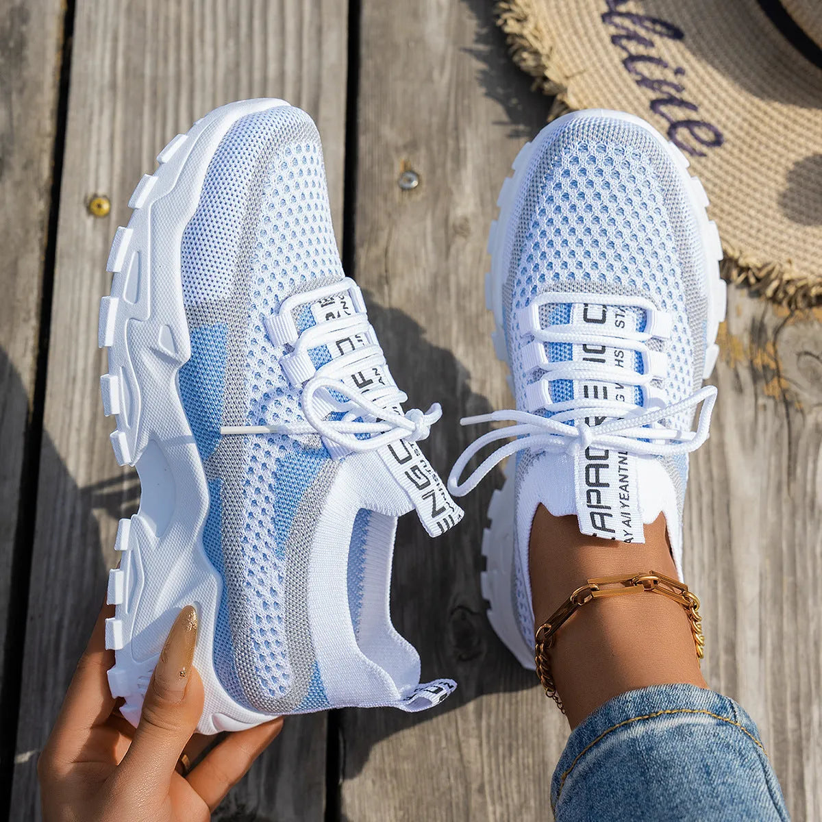 Women's Flyknit Mesh sneakers in a neutral colour showing lace-up design and rubber sole.