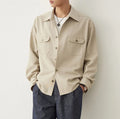 Men's simple profile lapel shirt in light sand rice colour, showing long sleeves and front button placket.