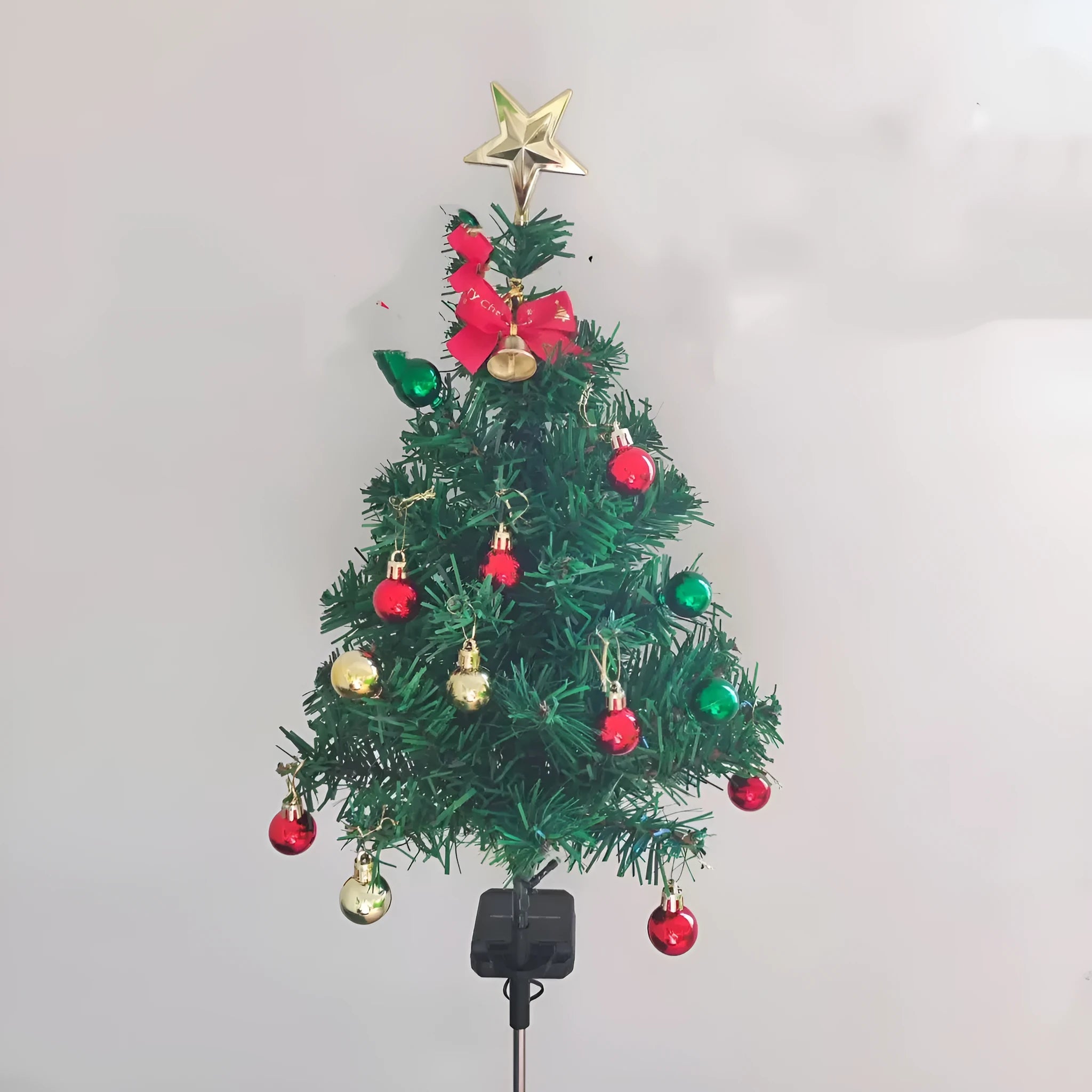 Solar Christmas tree lamp with ABS body placed on grass in a garden setting