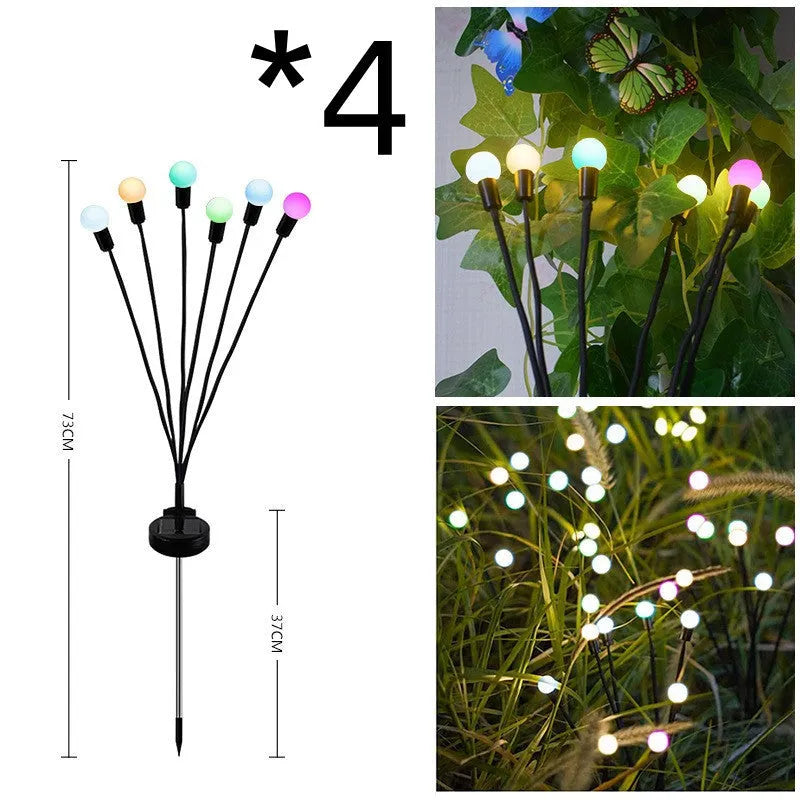 Solar-powered LED firefly lawn light with ground stake inserted in grass