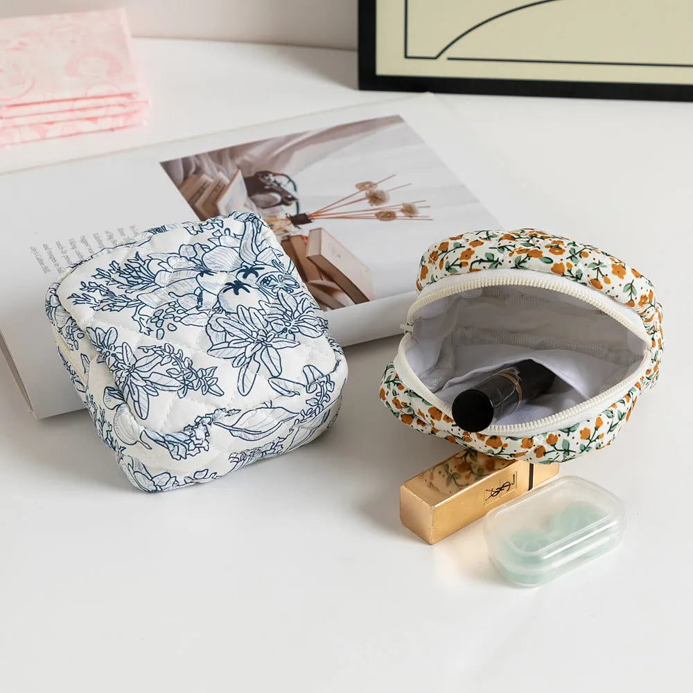 Women's floral patterned polyester key storage bag with sewing thread detail.