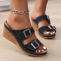 Women's creamy-white beach slippers with a decorative wedge buckle on the strap.
