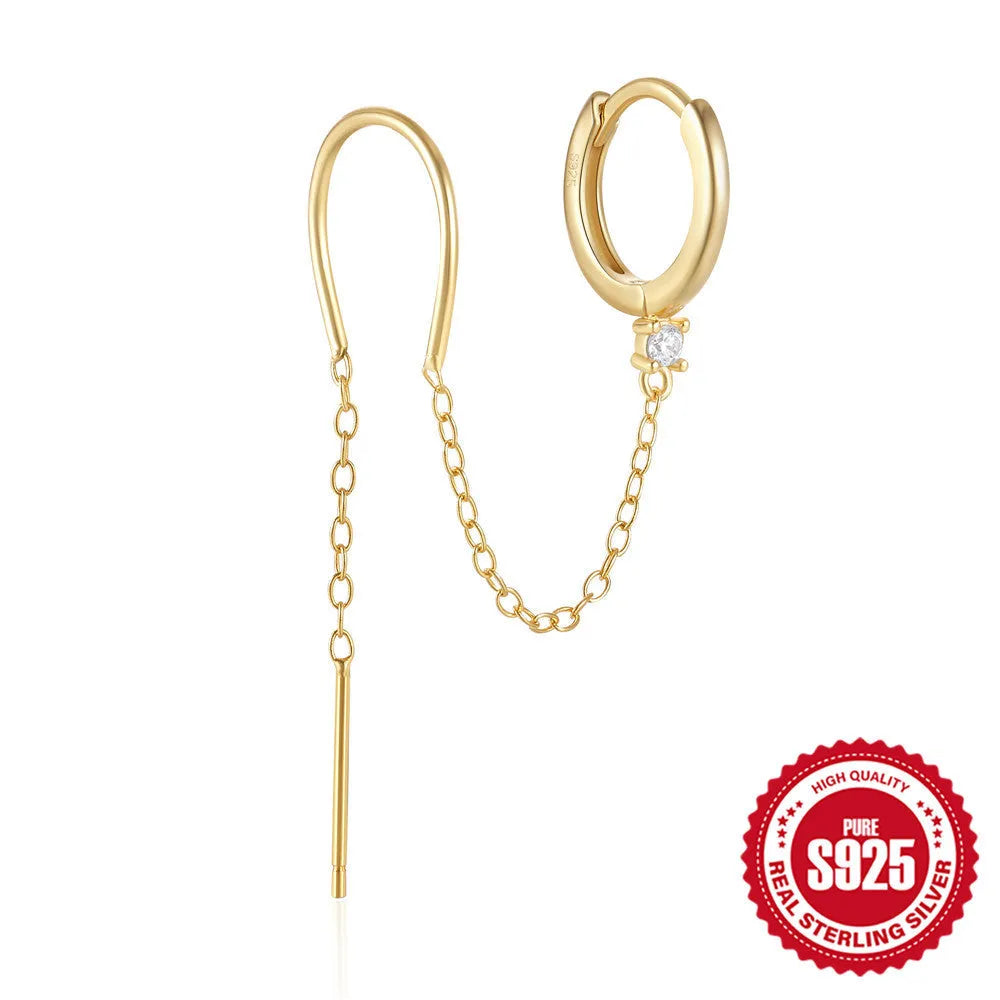Close-up of a women's S925 sterling silver stud earring with a diamond flower, chain, and tassel design in a gold colour.
