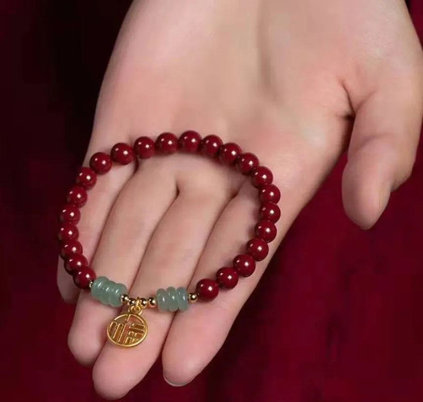 Gold cinnabar and copper wave bracelet in pumpkin or brand colour on wrist.