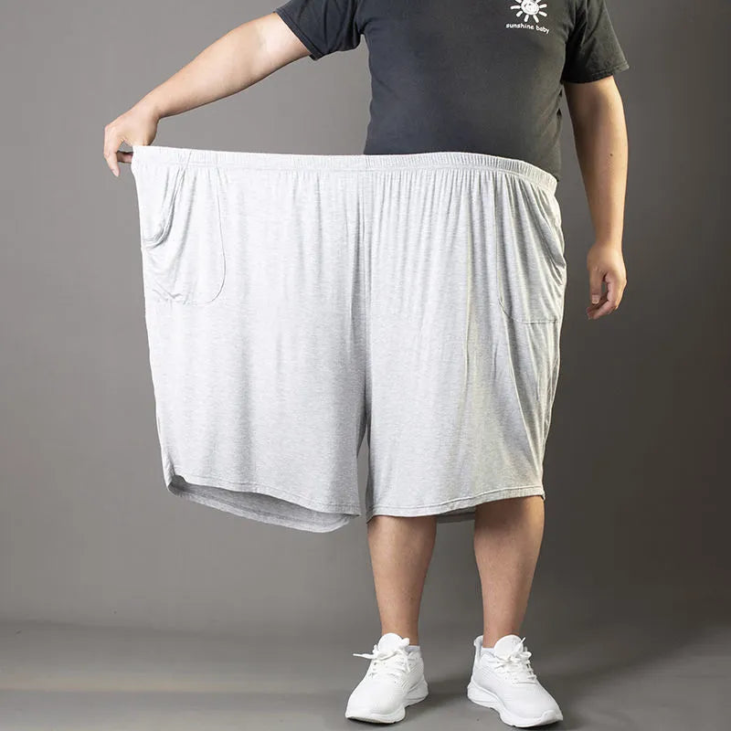 Plus-sized man wearing black loose fit modal sports trousers