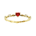 Gold tone peach heart ring with zircon stone centre on finger