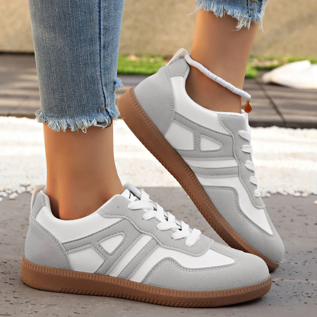 Retro women's jogging shoes in black with lace-up front, cross strap, and platform heel design