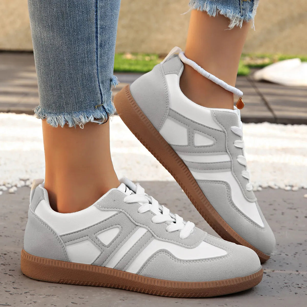 Retro women's jogging shoes in black with lace-up front, cross strap, and platform heel design