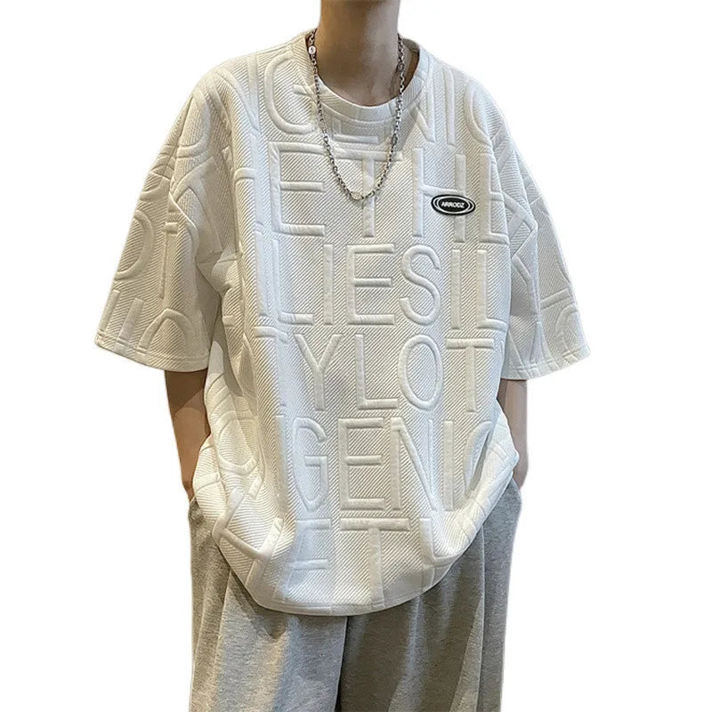 Men's grey loose-fit T-shirt with a raised white three-dimensional letter print on the chest.