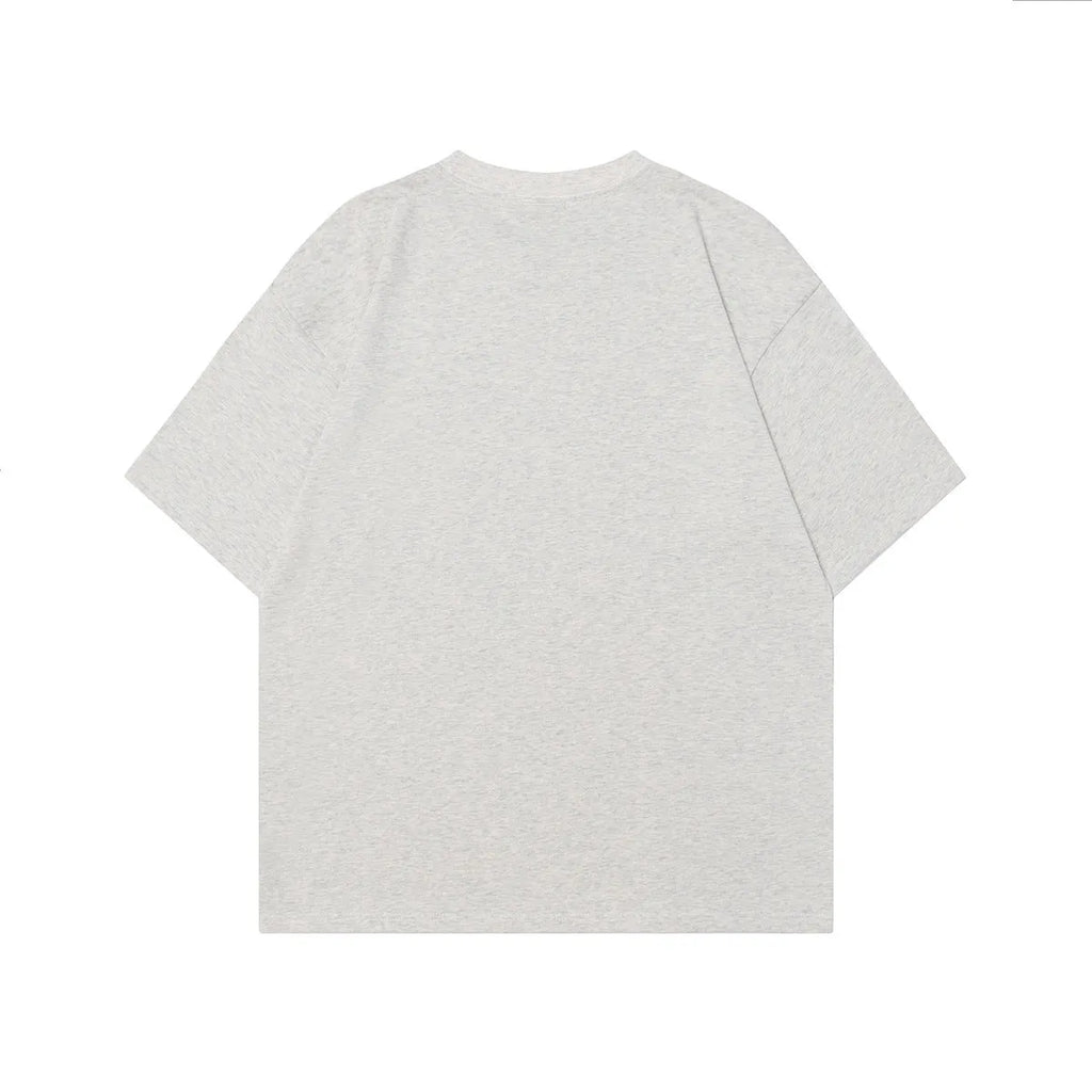 Men's grey cotton T-shirt with a retro character print, shown in a loose fit.