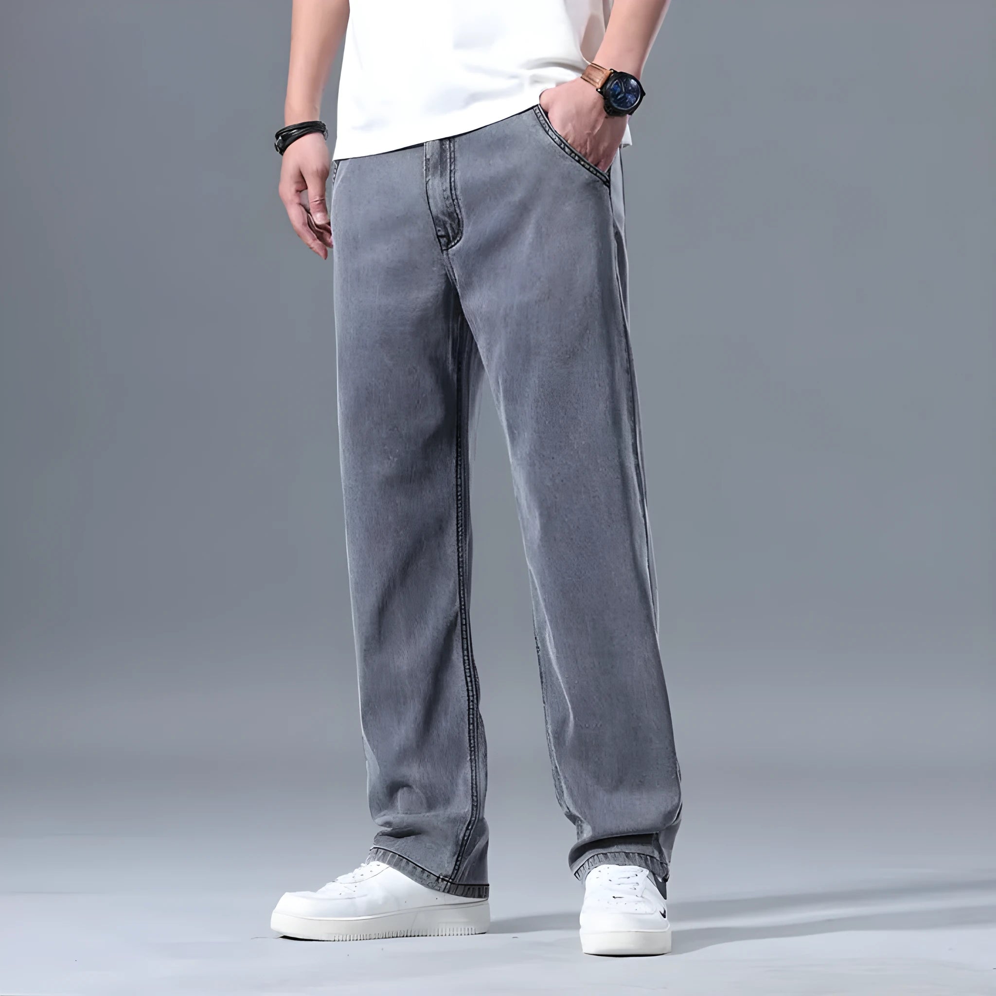 Man wearing light blue loose straight-leg Lyocell jeans with a zipper fly.