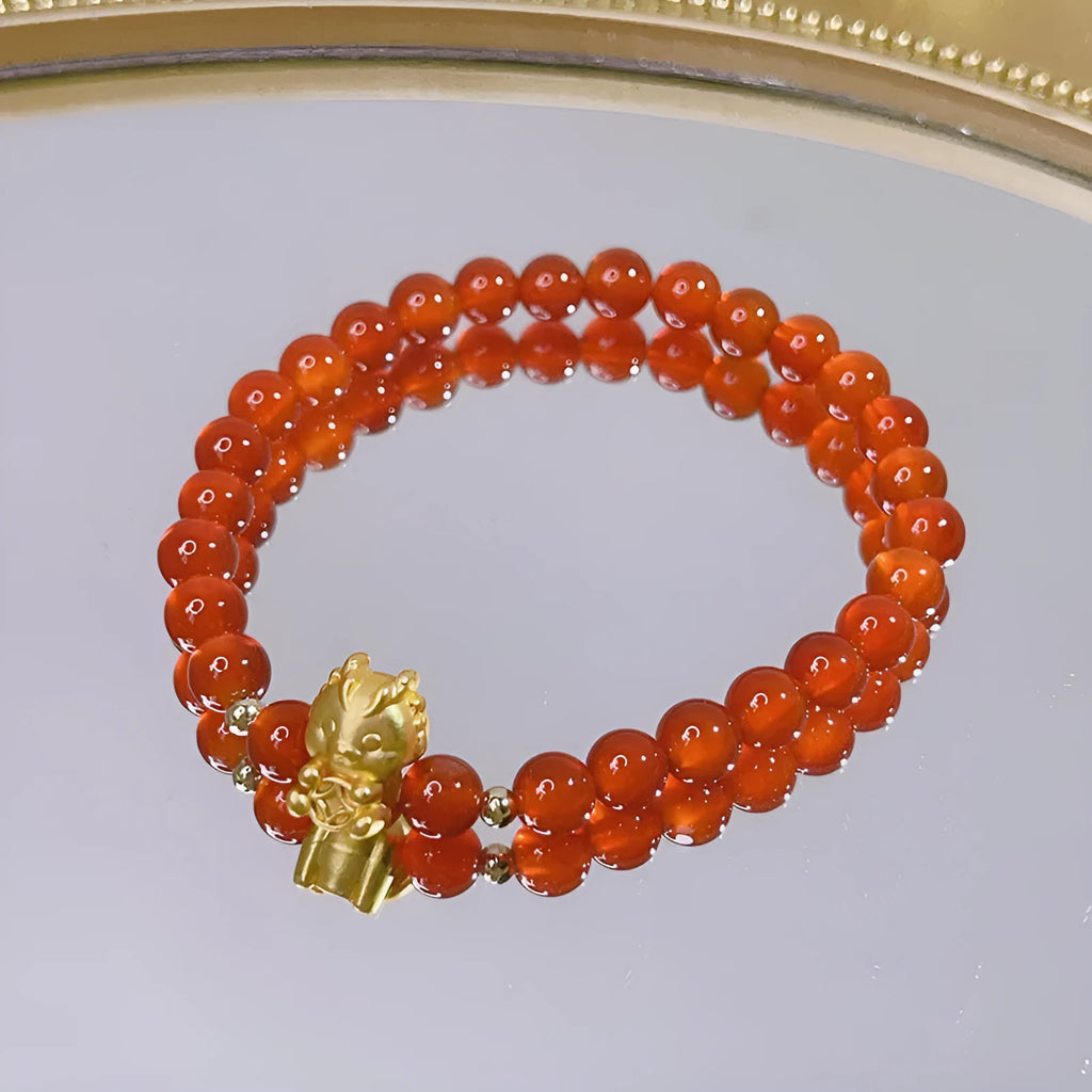 Handmade red agate bracelet with dragon and lucky bag Chinese designs for women.