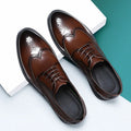 Men's black brogue leather shoes with traditional perforations and Oxford-style construction