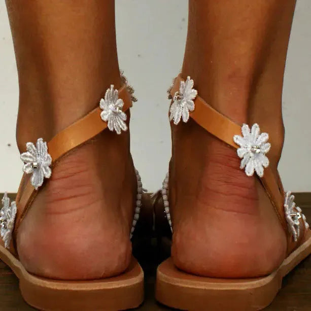 Brown ladies flat sandals with flower decorations and herringbone toe pattern