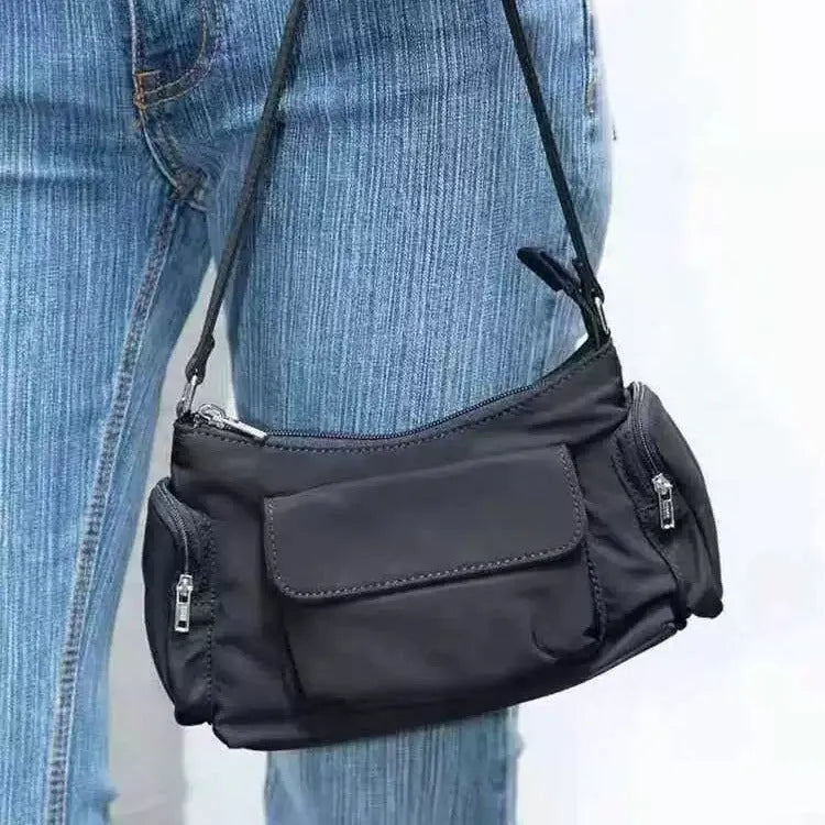 Black lightweight women's shoulder bag made of PU leather with double pockets and side line details.