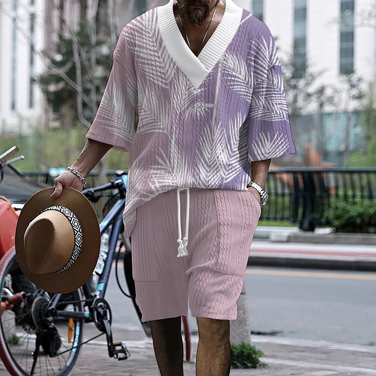 Printed men's knitted drop-shoulder short-sleeved top and matching shorts set in a polyester blend.