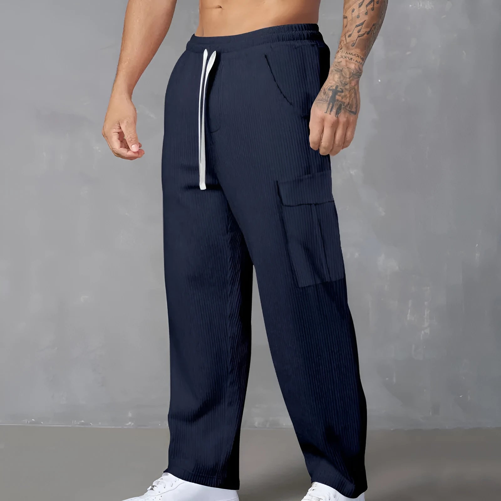 Men's loose-fitting corduroy cargo trousers in navy blue with straight wide-leg cut and elasticated waist