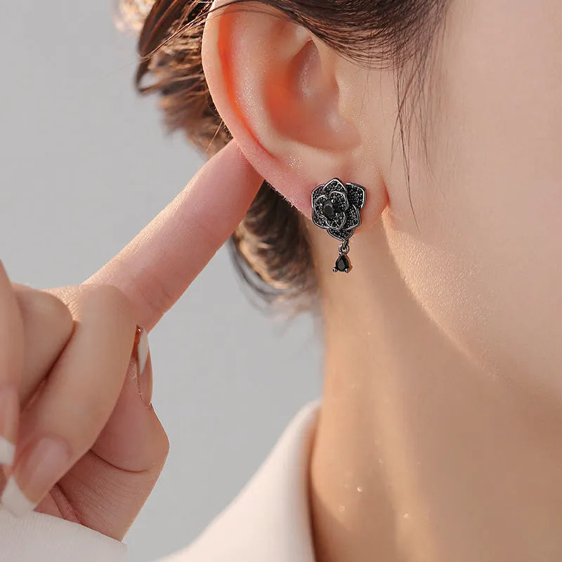 Women's rose gold plated flower ear studs with black zircon stones
