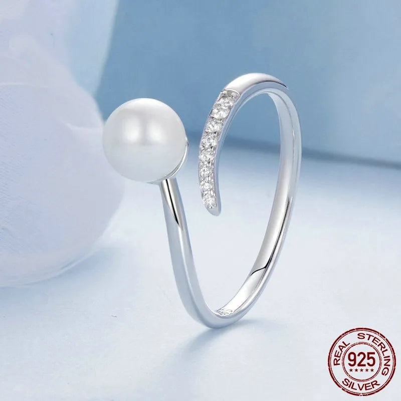Adjustable sterling silver ring with natural shell pearls showing open loop design