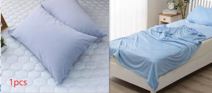 Blue and grey cooling blanket with Japanese Q-Max fibres on a bed.
