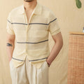 Camel coloured linen cotton short sleeve cardigan with a lapel collar laid flat.