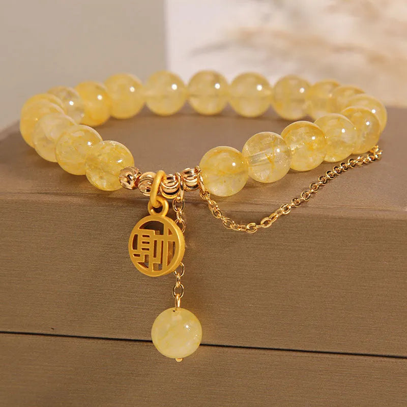 Natural citrine bracelet with gold electroplated Chinese character charm on adjustable tassel