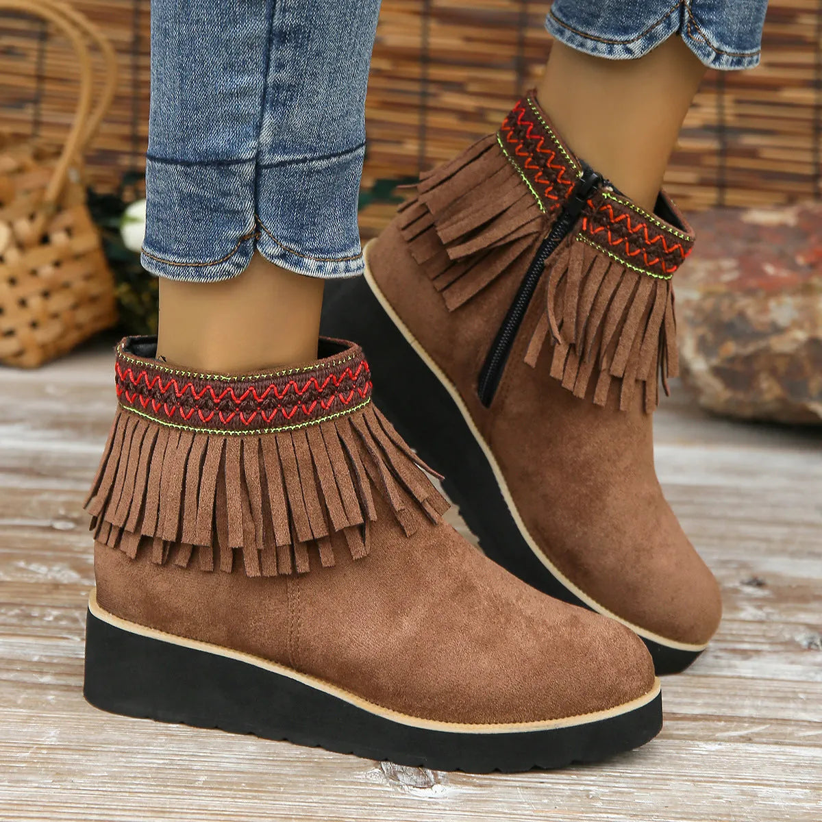 Women's dark brown suede ankle boot with wedge heel, side zipper, and decorative tassel.