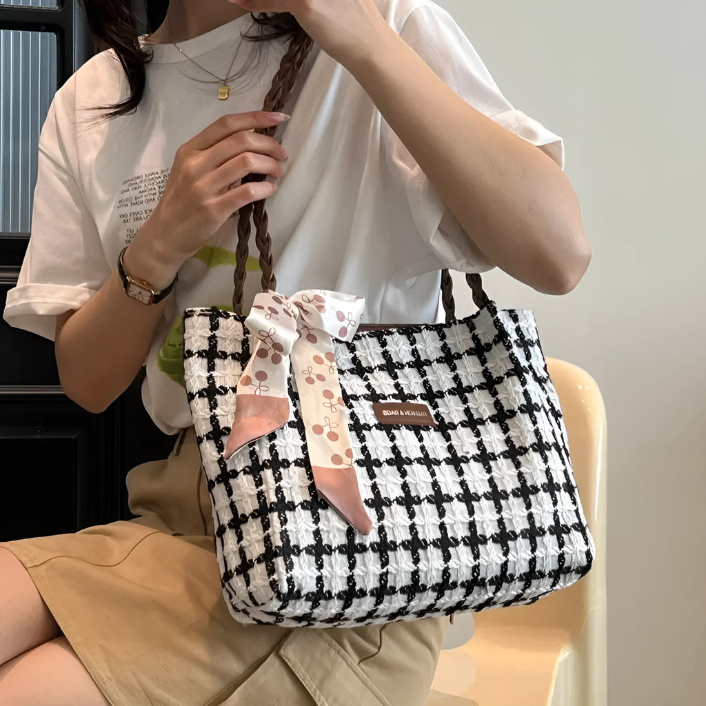 Black woven wool shoulder bag showing internal organisation with phone pocket, document section and zipper compartment