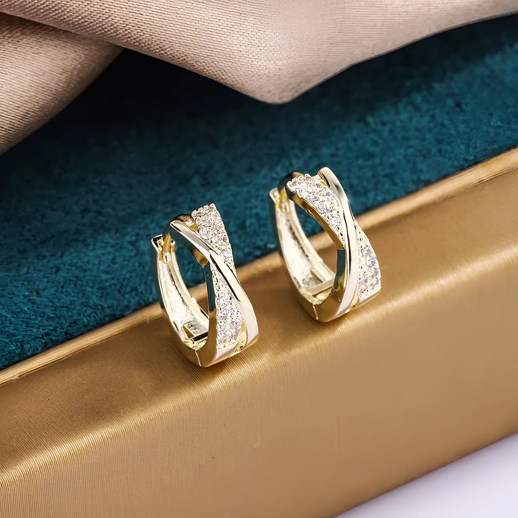 Geometric earrings with copper construction and 14K yellow finish featuring zircon sparkle treatment