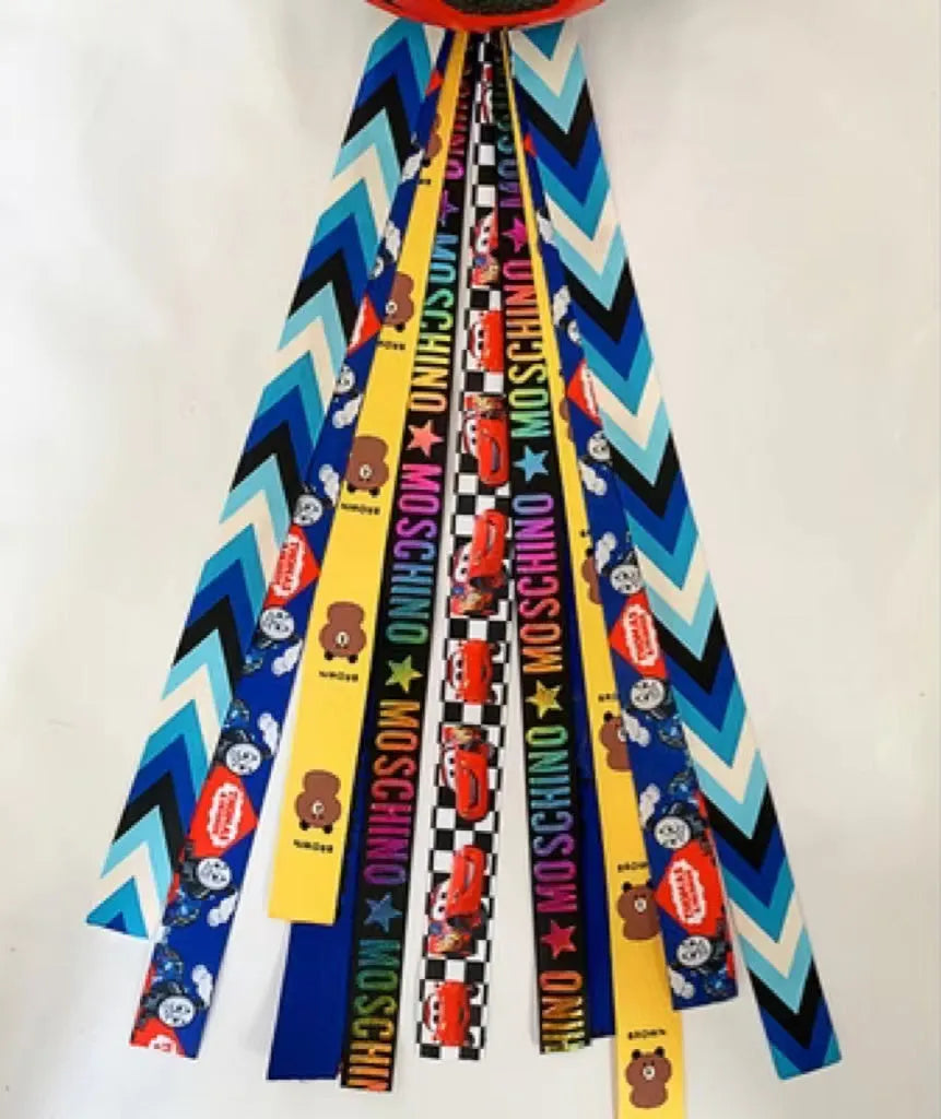 A colourful helmet streamer accessory for children's sports helmets and doll decoration.