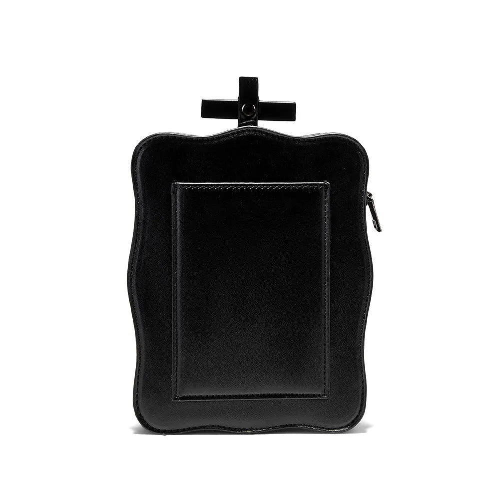 Black mini square crossbody bag with 3D embossed skull design, stitching details, and metal rivets