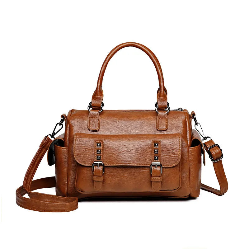 Vintage messenger bag in horizontal square shape showing stitching details and shoulder strap