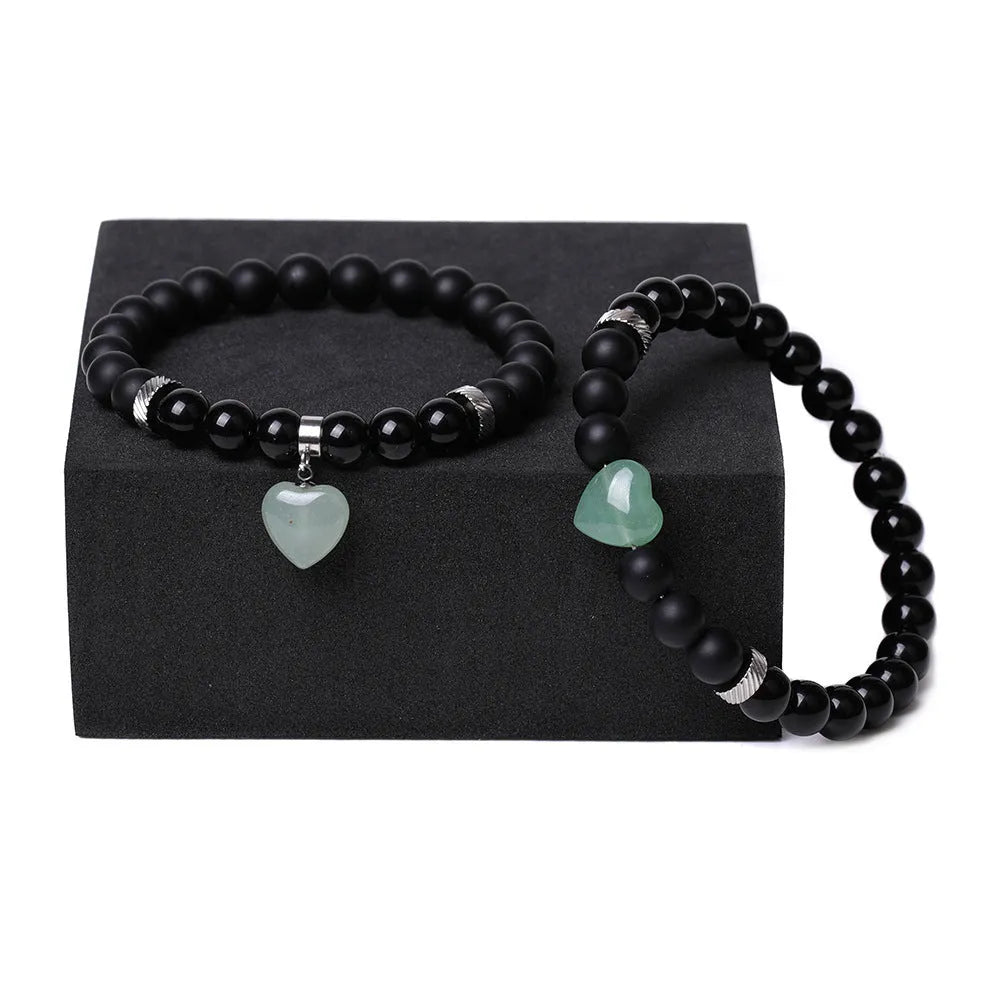 Natural stone couple bracelet set showing two matching bracelets with heart-shaped polished stone charms