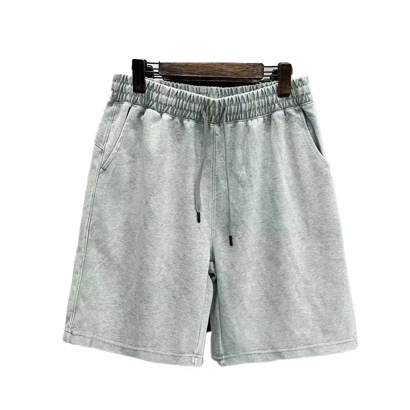 Men's straight-leg cotton casual shorts in distressed navy blue colour showing loose fit and fifth-pants length