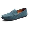 Men's suede slip-on loafers in black on a flat rubber sole, showing round toe and sewing detail.