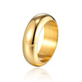 Glossy electroplated titanium steel ring in gold, black, and steel colours on a grey background.