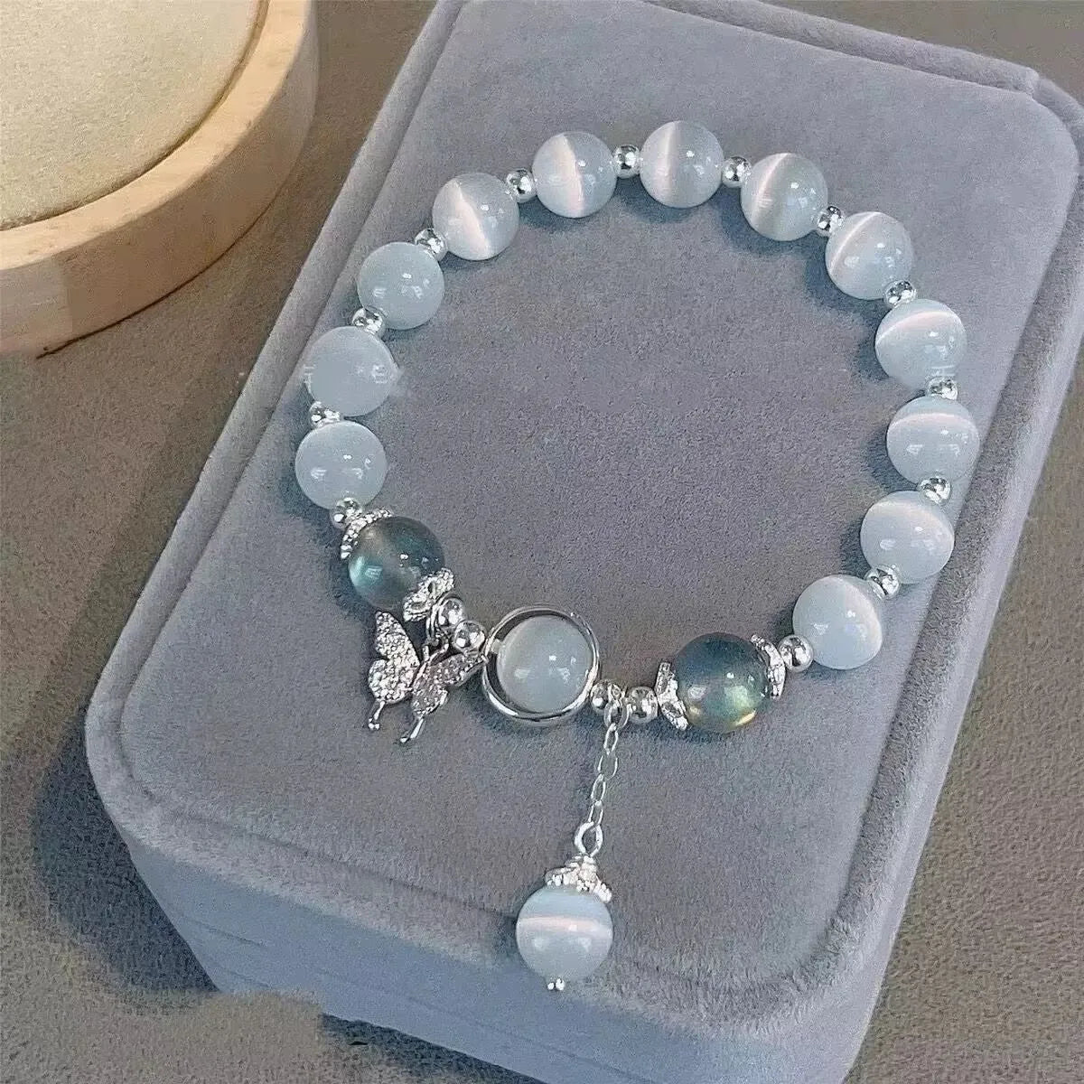 Handcrafted glass butterfly bracelet with drop-shaped moonlight grey beads and special-interest design