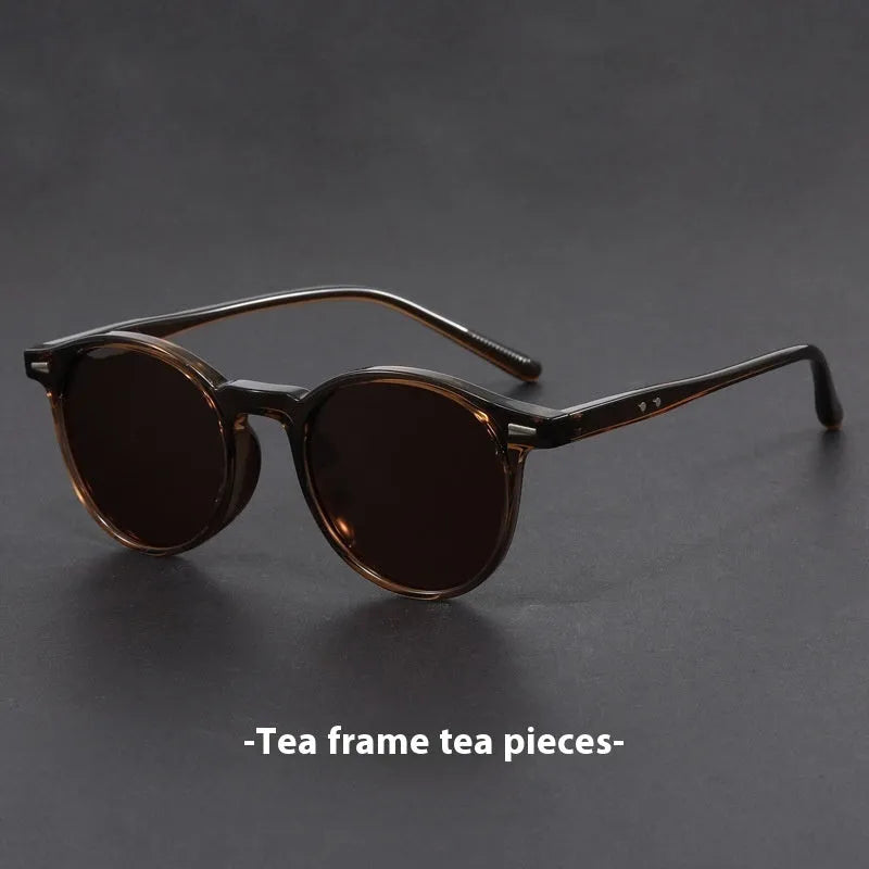 Retro oval sunglasses with ultra-lightweight round frame and polarised grey lenses.