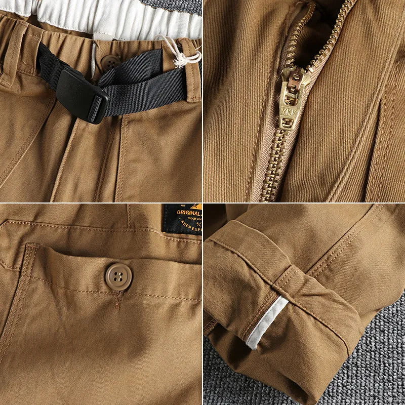 Men's khaki cotton work trousers with N I buckle belt and three-dimensional cut on a hanger.
