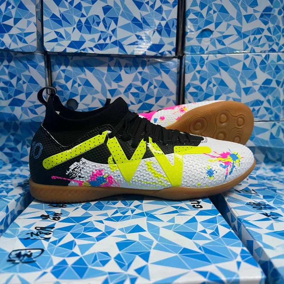 Adult low-top football boots with PVC upper and replaceable studs in black and yellow colourway