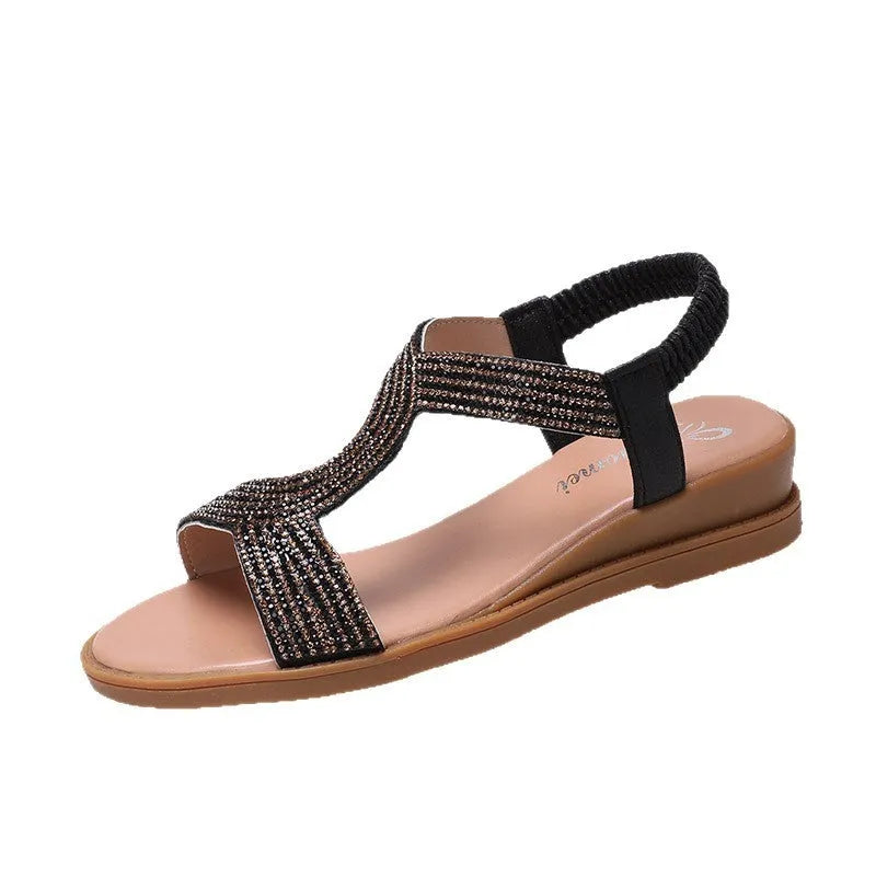 Gold women's patent leather sandals with rhinestone decoration and a non-slip sole.