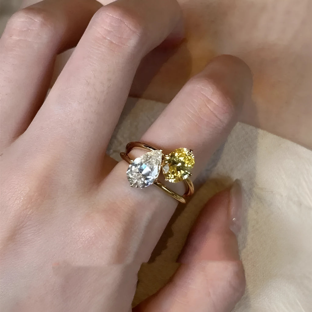 Open geometric ring with water drop shaped zircon stones in contrasting colours