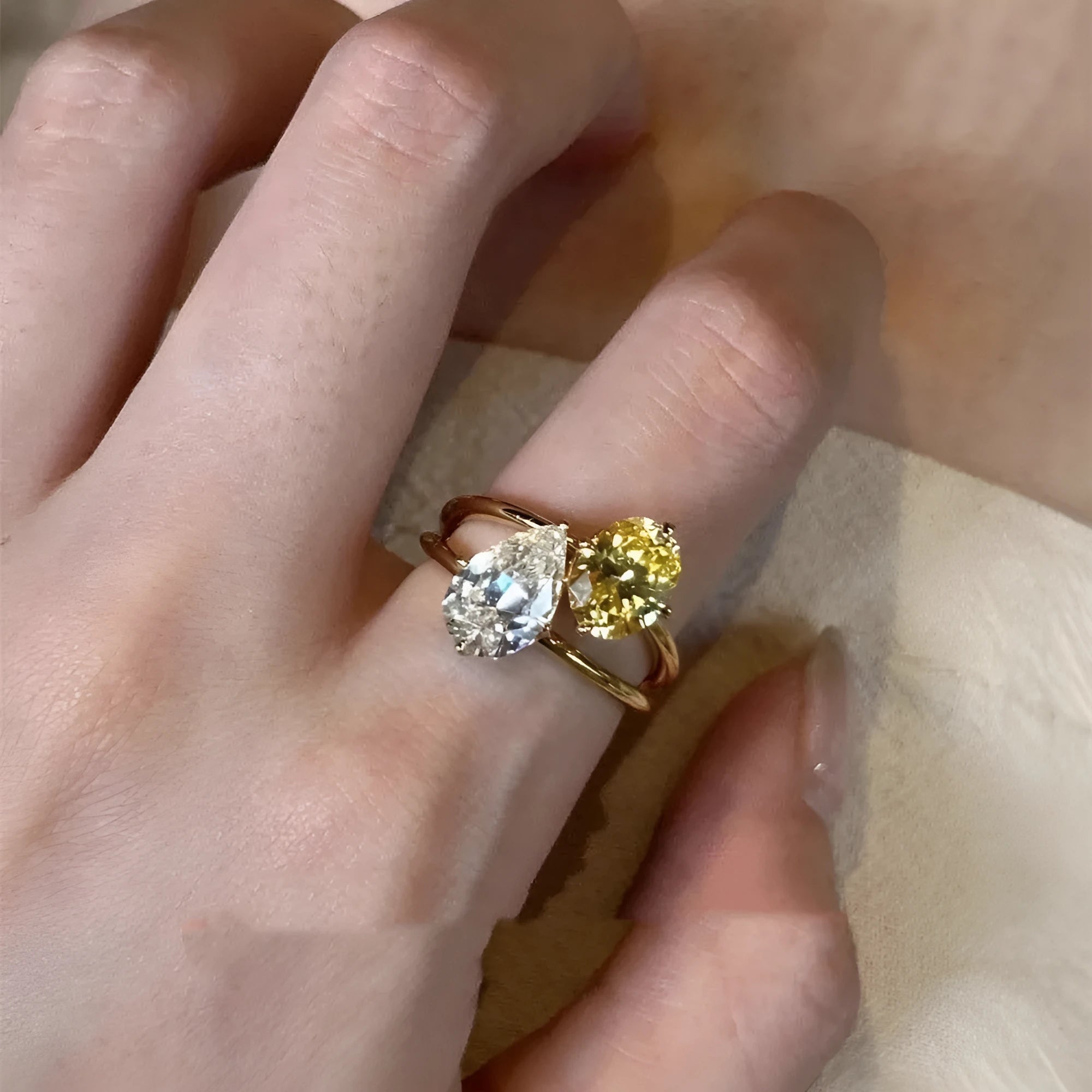 Open geometric ring with water drop shaped zircon stones in contrasting colours